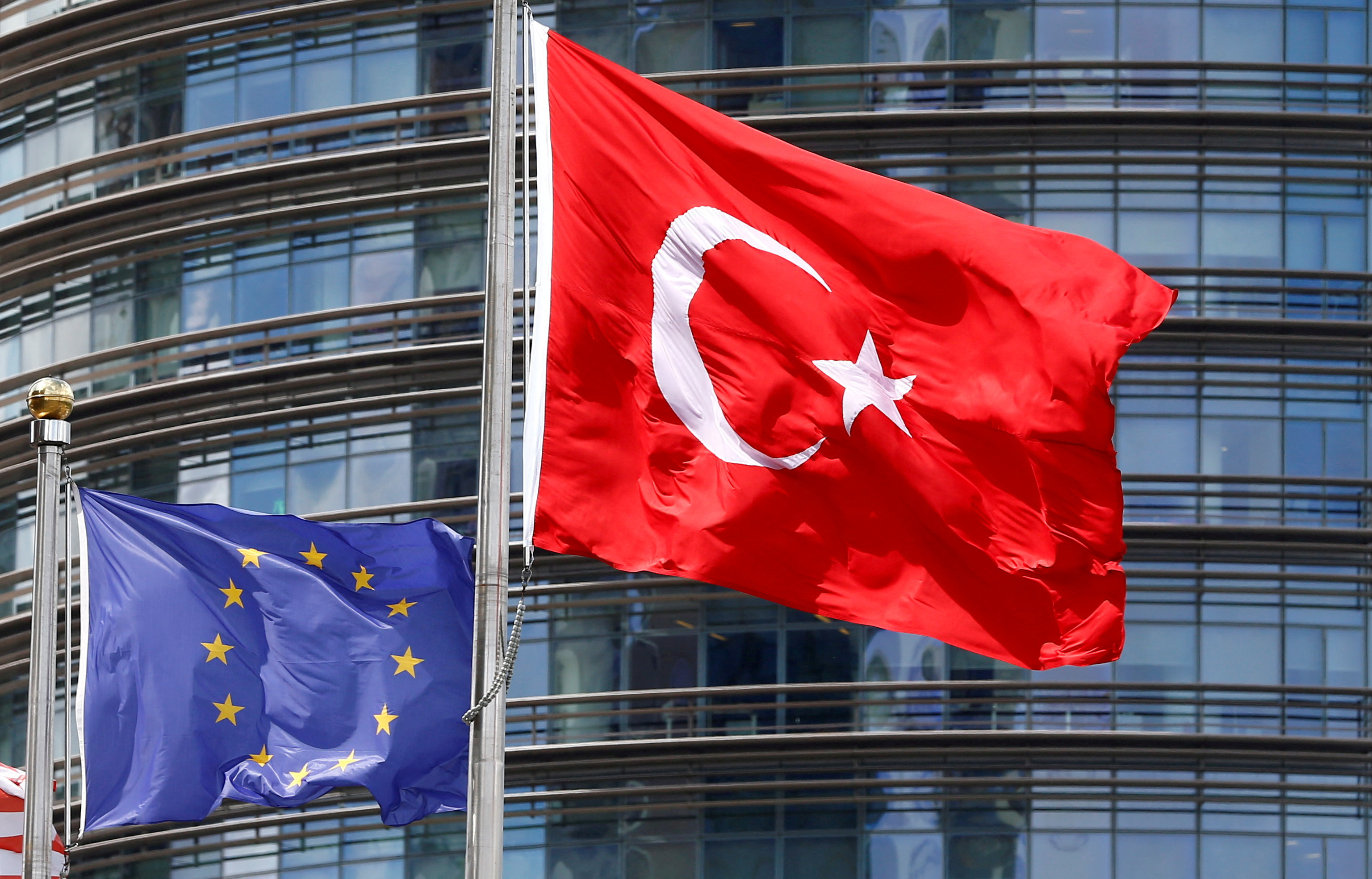 FILE PHOTO: A European Union and Turkish flag fly outside a hotel in Istanbul