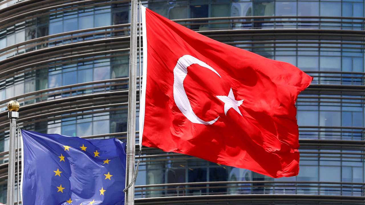 FILE PHOTO: A European Union and Turkish flag fly outside a hotel in Istanbul