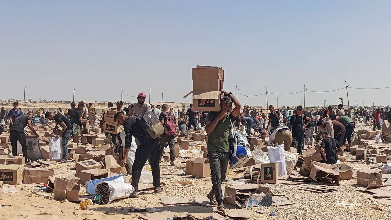 Palestinians gather to collect what remains of relief supplies of the U.S.-backed Gaza Humanitarian Foundation, in Rafah