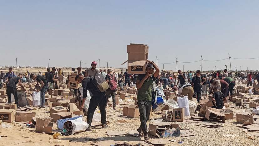 Palestinians gather to collect what remains of relief supplies of the U.S.-backed Gaza Humanitarian Foundation, in Rafah