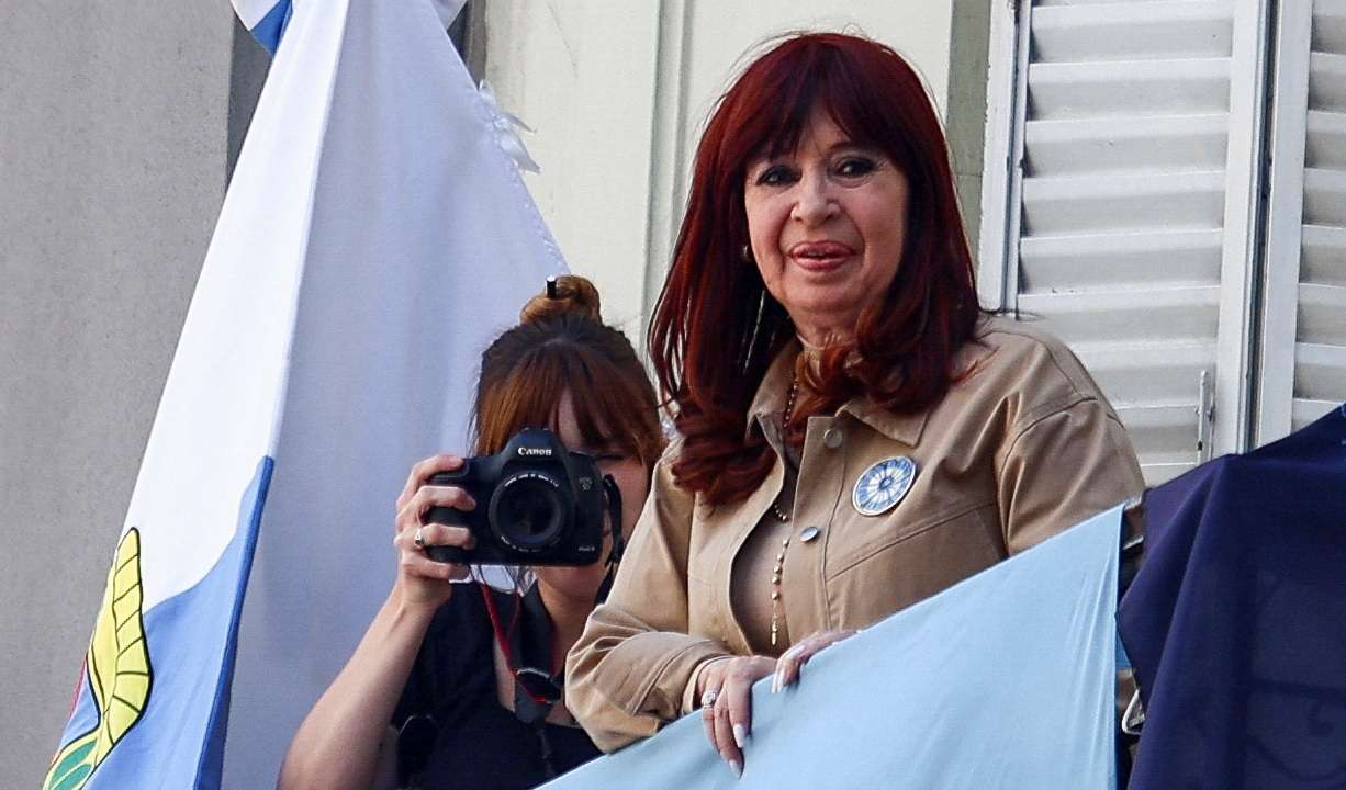 Argentina's former President Cristina Fernandez de Kirchner stands on a balcony