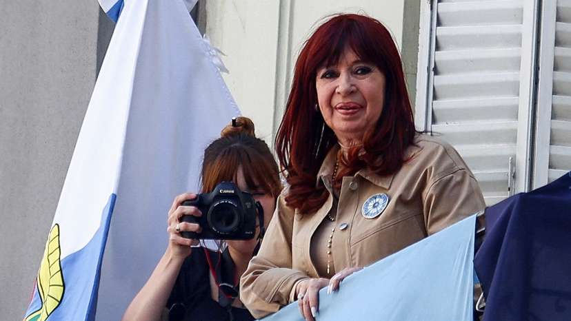 Argentina's former President Cristina Fernandez de Kirchner stands on a balcony