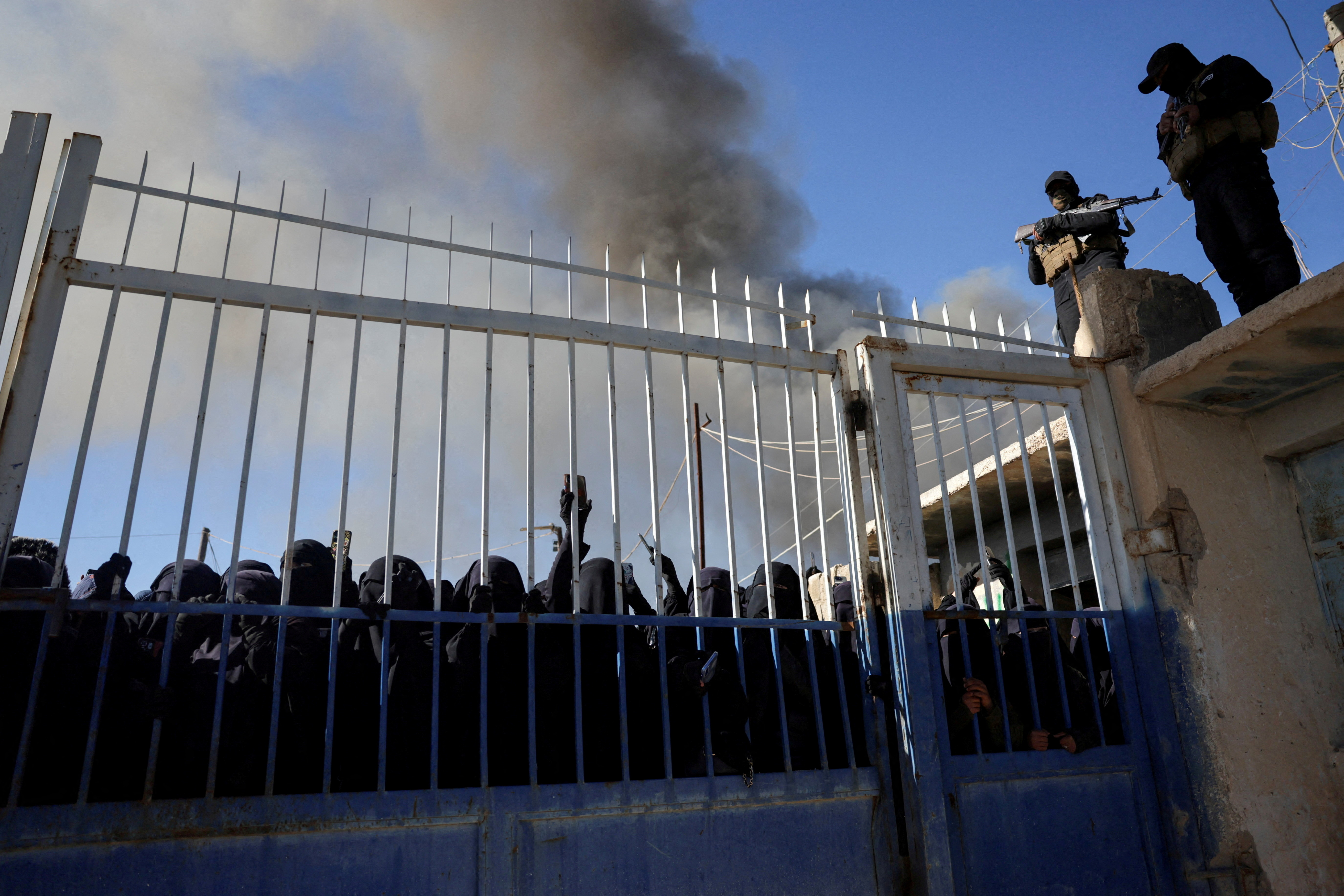 FILE PHOTO: Detainees gather at al-Hol camp after the Syrian government took control of it, in Hasaka