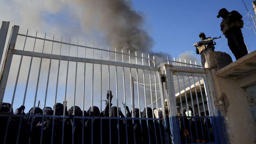 FILE PHOTO: Detainees gather at al-Hol camp after the Syrian government took control of it, in Hasaka