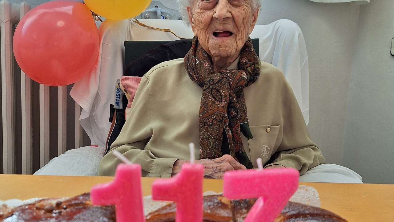 Maria Branyas, poses in front of a birthday cake as she celebrates her 117th birthday in a nursing home, in Girona