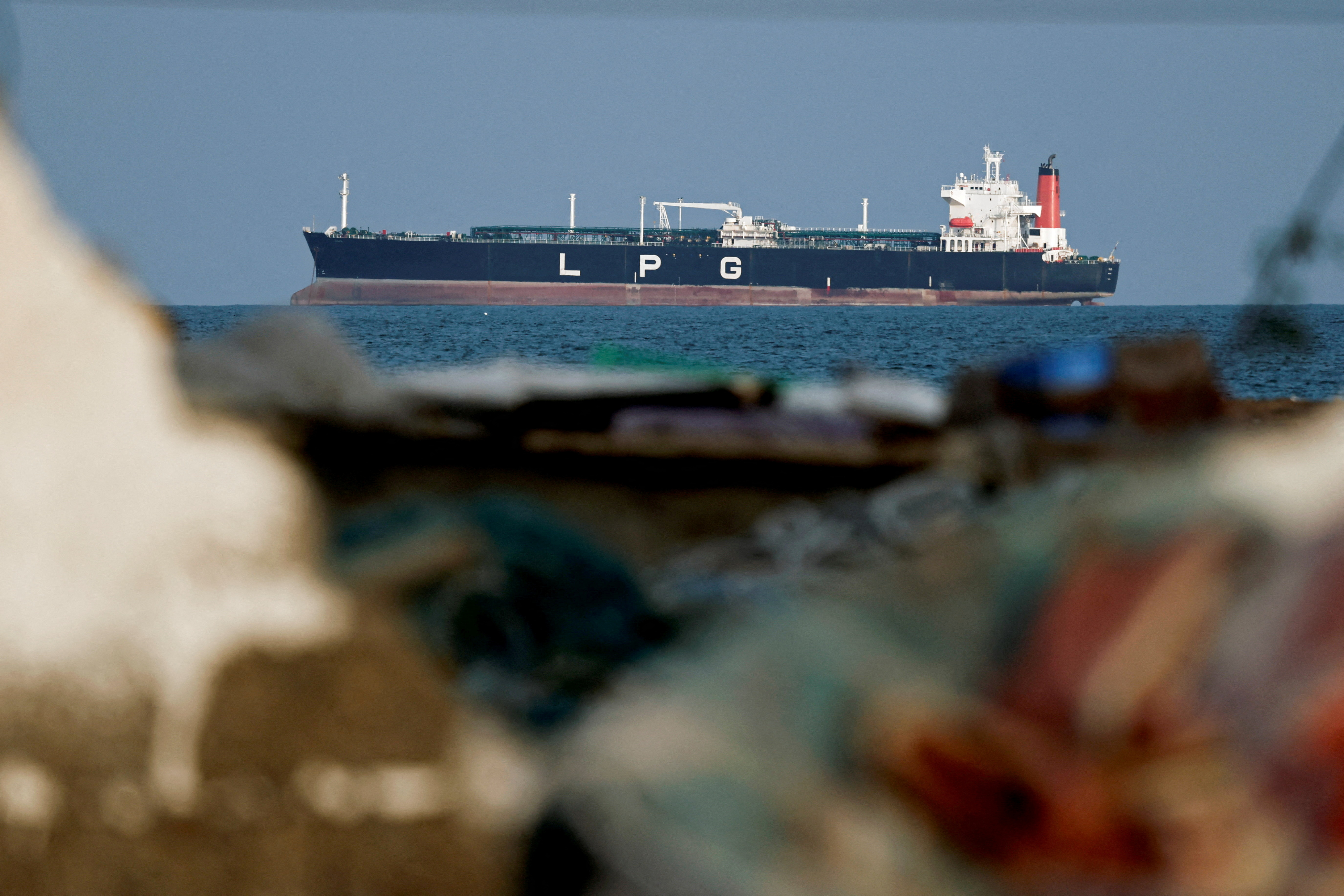 FILE PHOTO: An LPG gas tanker at anchor as traffic is down in the Strait of Hormuz, in Shinas