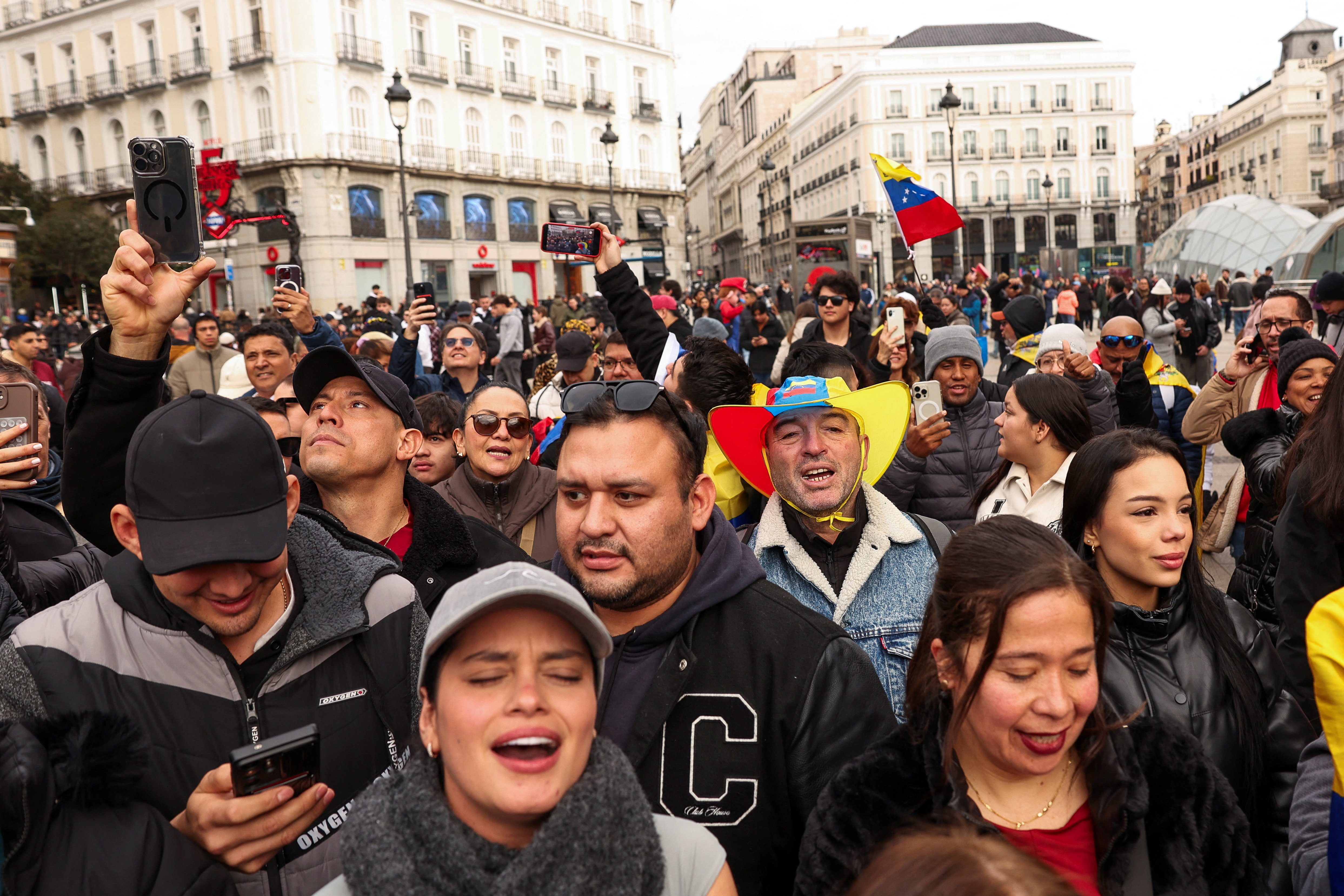 People react to the news of U.S. strikes on Venezuela and capture of President Maduro, in Madrid