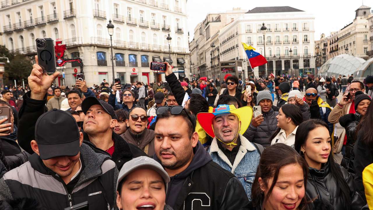 People react to the news of U.S. strikes on Venezuela and capture of President Maduro, in Madrid