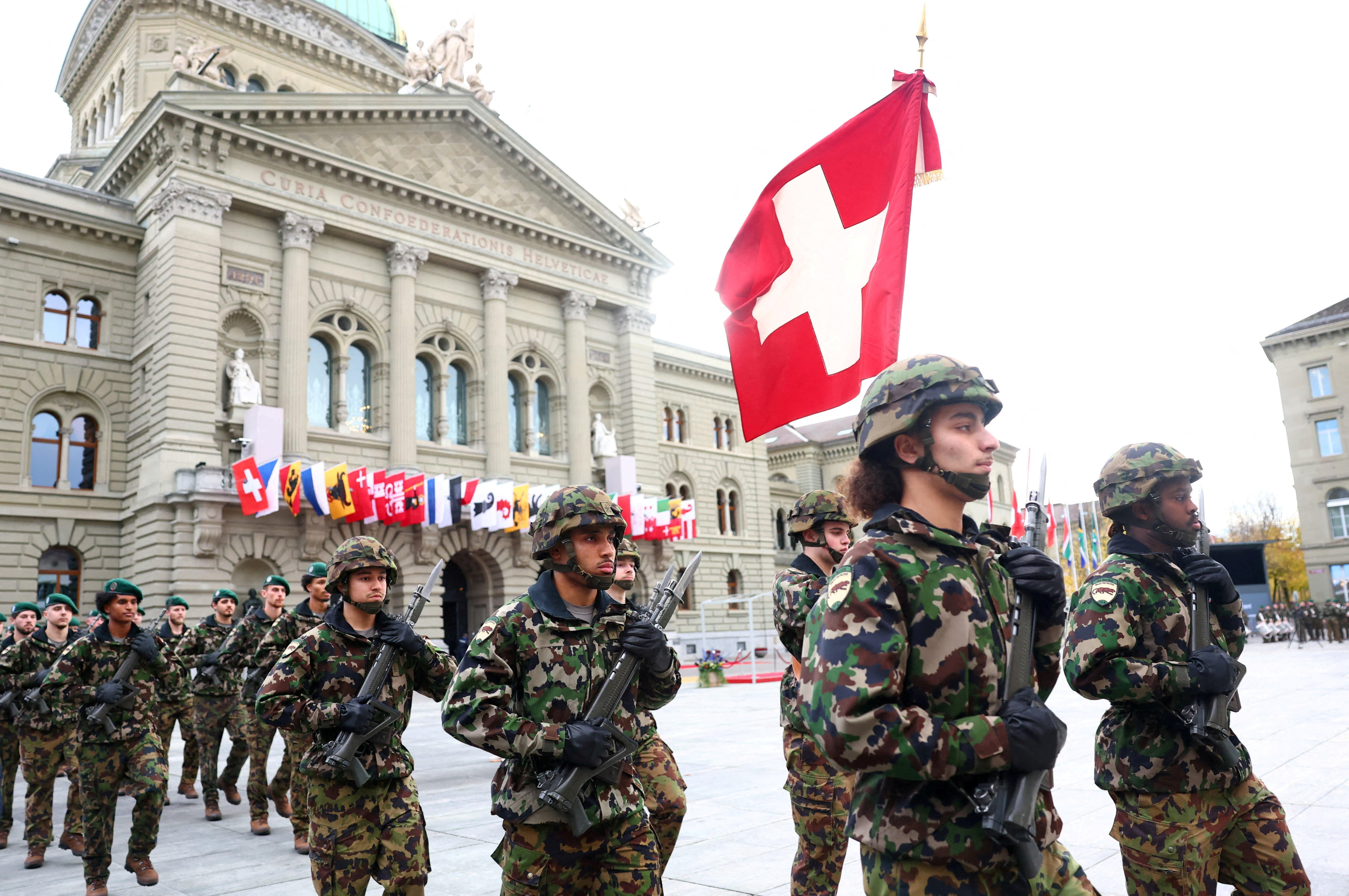 FILE PHOTO: Soldiers from the Swiss army's Infantry Readiness Company 104/1 and the Guard of Honour march past the Swiss Parliament building in Bern