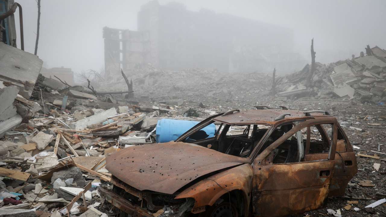 A destroyed car near apartment buildings damaged by Russian military strike in the frontline town of Kostiantynivka