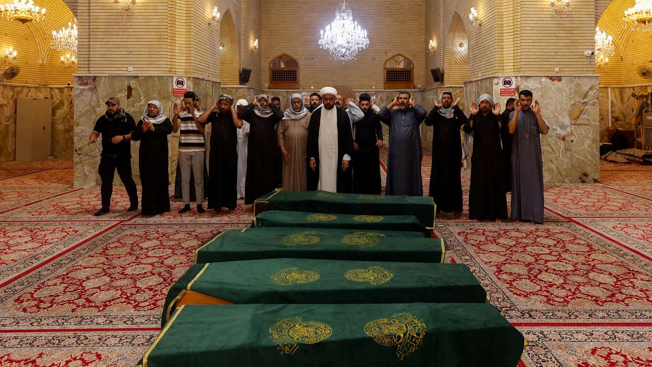 Mourners pray during the funeral of children killed after a refrigerator truck veered into a group of young people in Basra, in Najaf