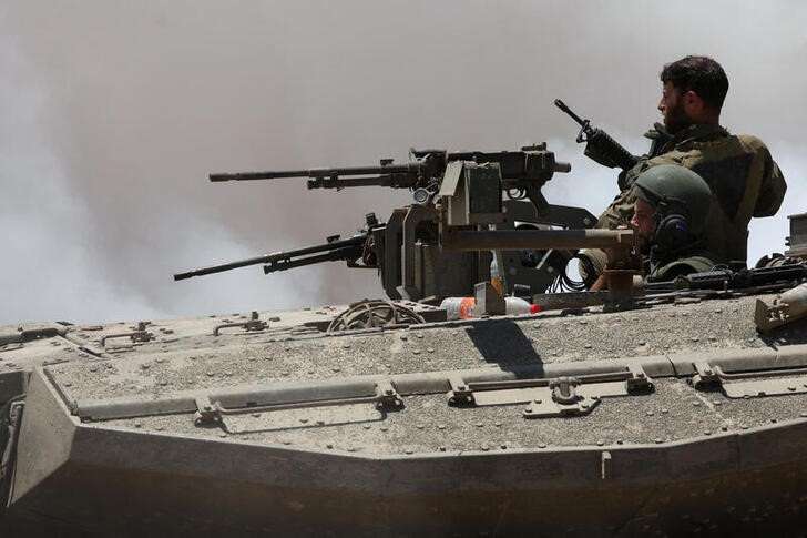 An Israeli tank manoeuvres near the Israel-Gaza border