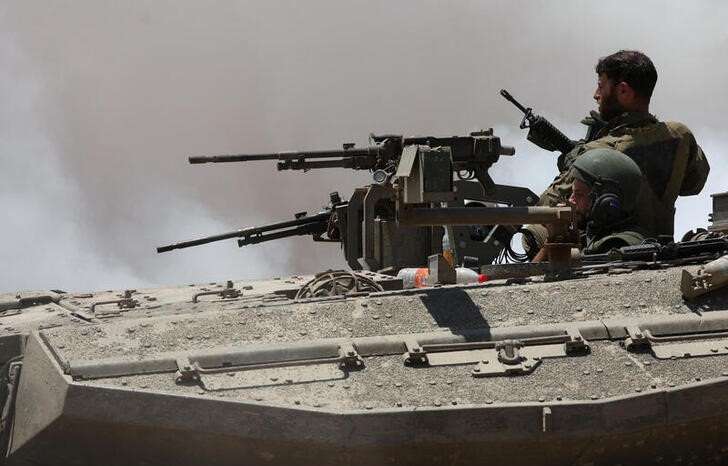 An Israeli tank manoeuvres near the Israel-Gaza border