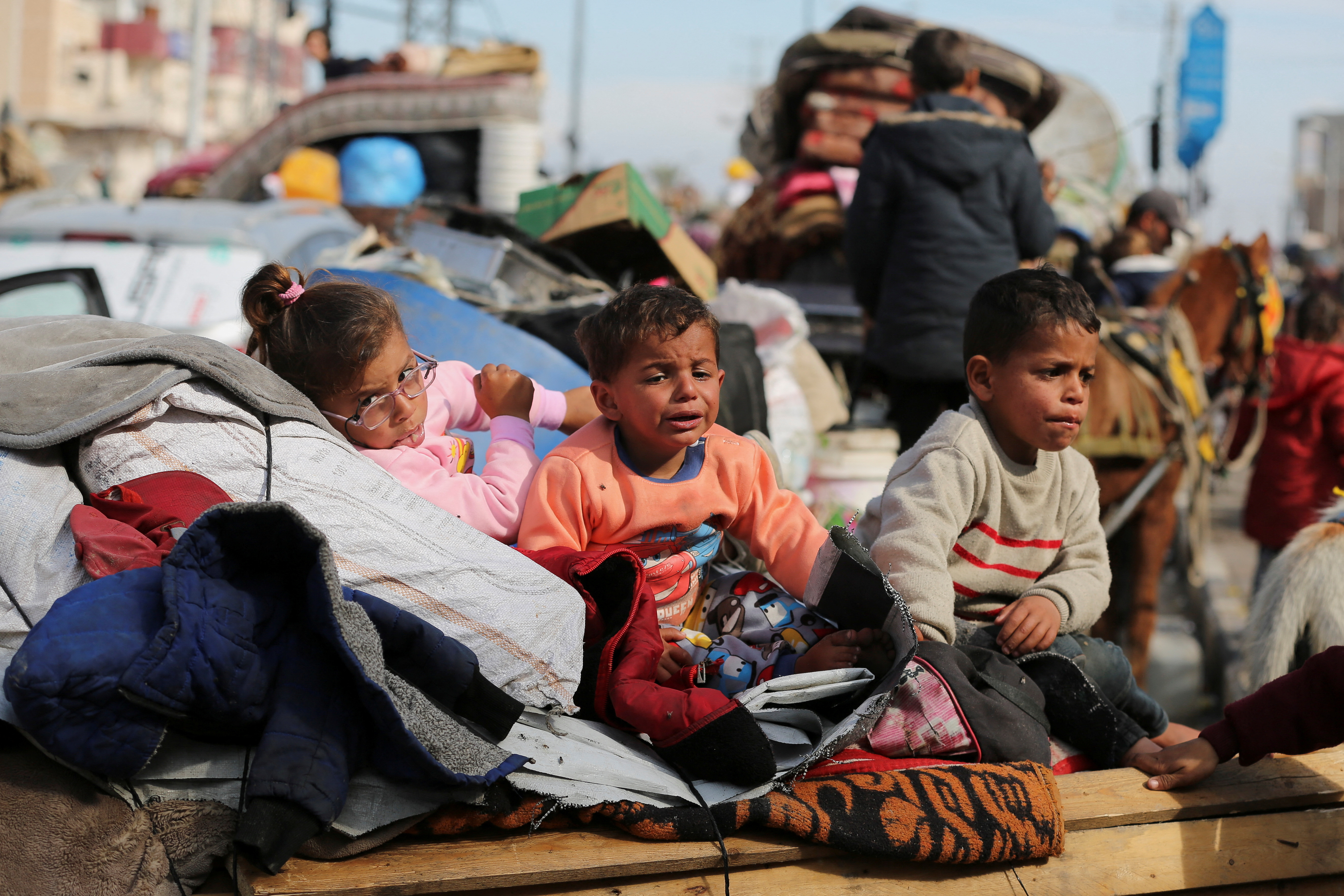 Displaced Palestinians wait to be allowed to return to their homes in northern Gaza, in the central Gaza Strip