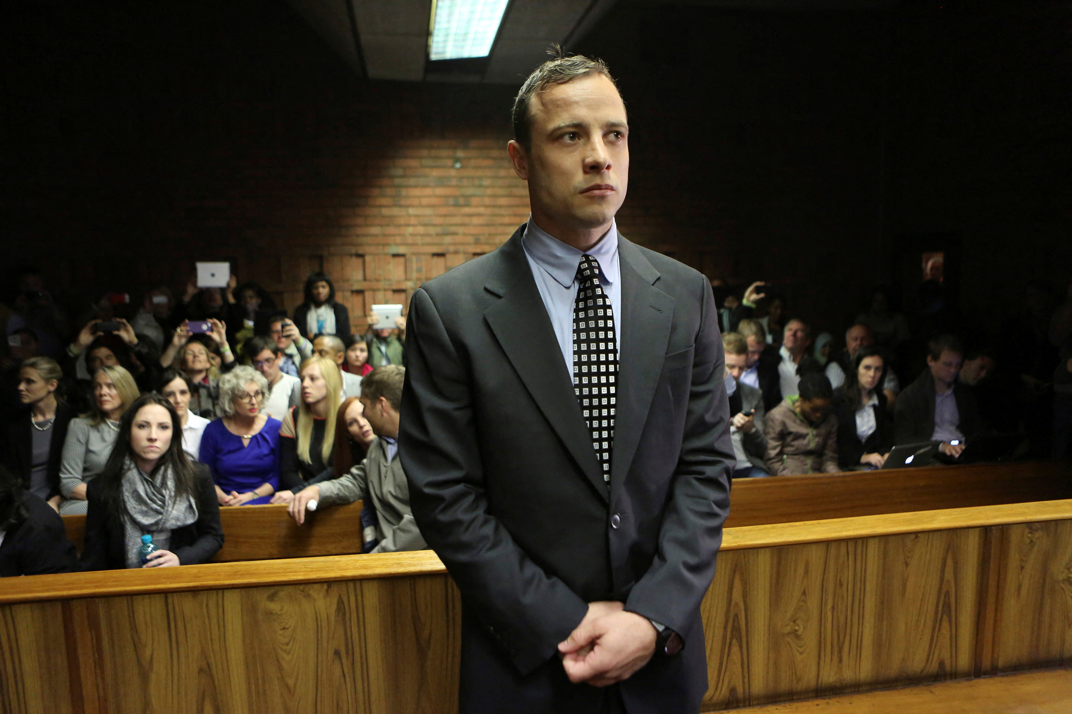 FILE PHOTO: Oscar Pistorius enters the dock before court proceedings at the Pretoria Magistrates court