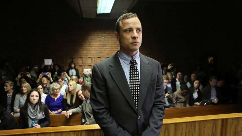 FILE PHOTO: Oscar Pistorius enters the dock before court proceedings at the Pretoria Magistrates court