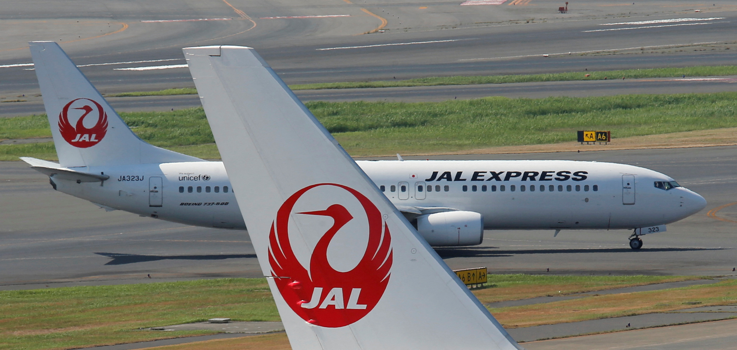 FILE PHOTO: Japan Airlines aircraft are seen on the tarmac at Haneda airport in Tokyo