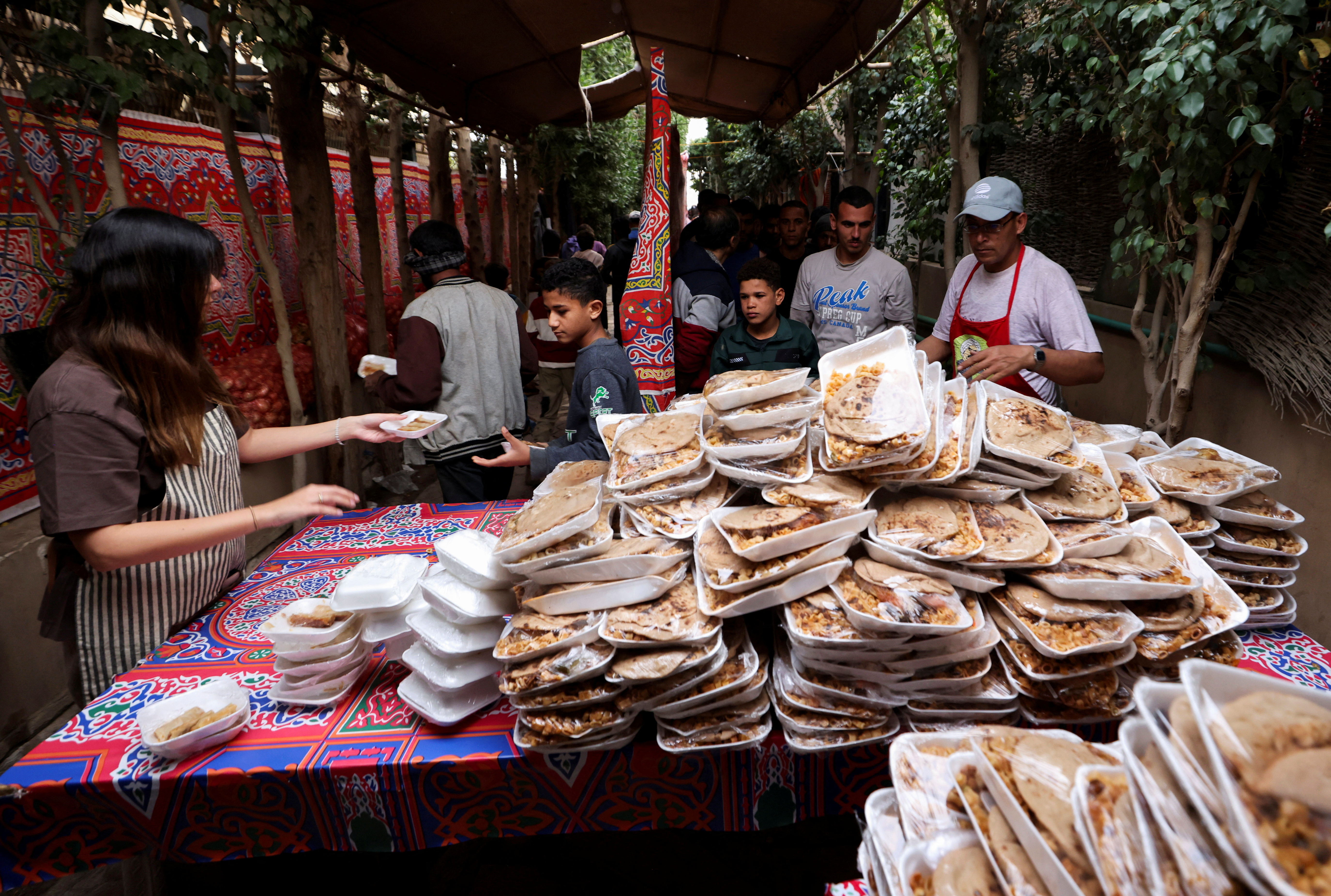 Hot meals are distributed during the holy month of Ramadan amid the economic crisis, in Cairo