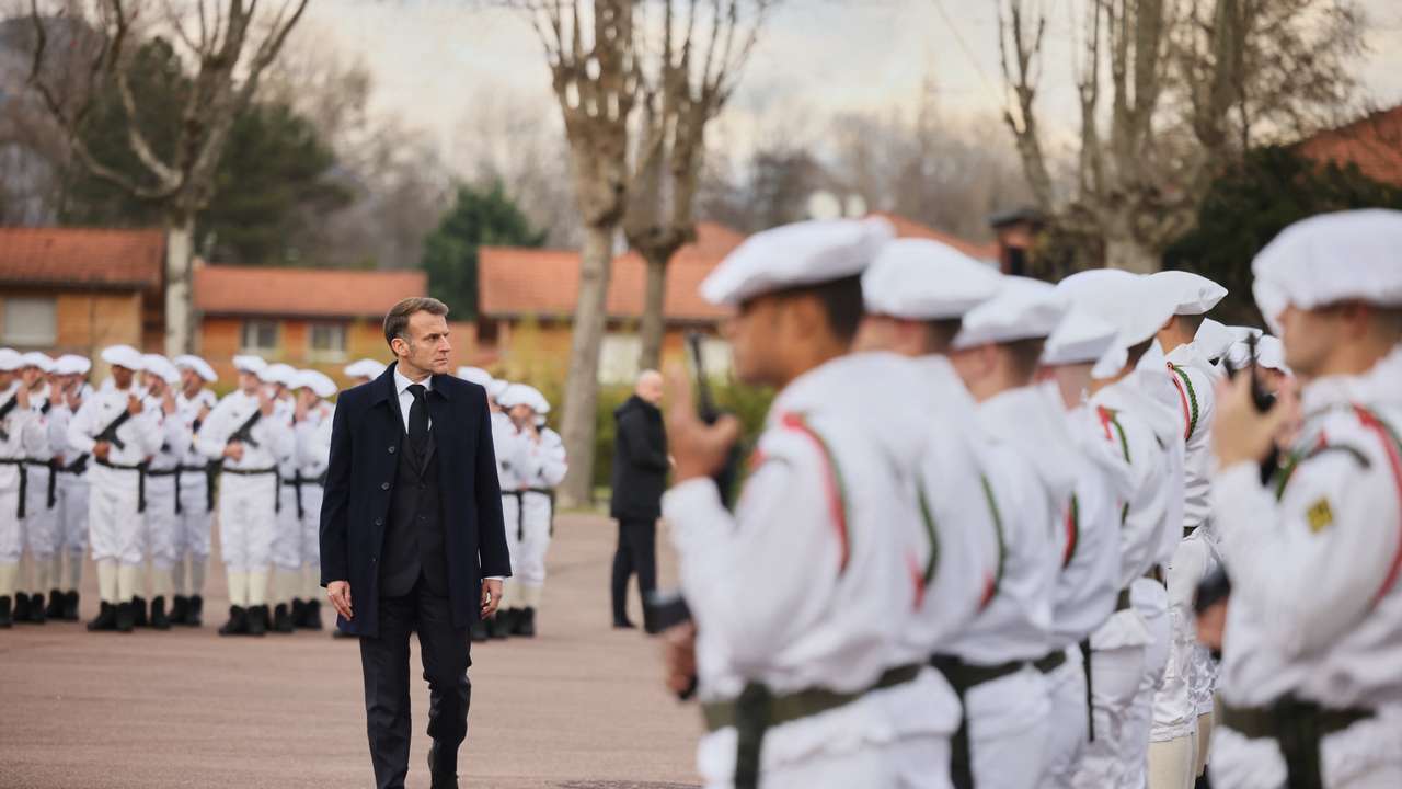 France's President Macron reviews the troops prior to his speech to unveil a new national military service at the military base in Varces