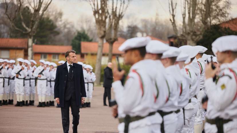 France's President Macron reviews the troops prior to his speech to unveil a new national military service at the military base in Varces