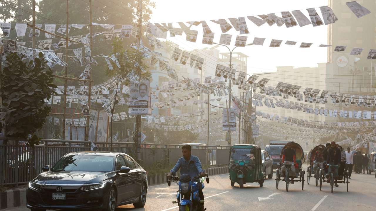 FILE PHOTO: Election campaign posters of Awami League hang on a road as traffic moves past ahead of the general election, in Dhaka