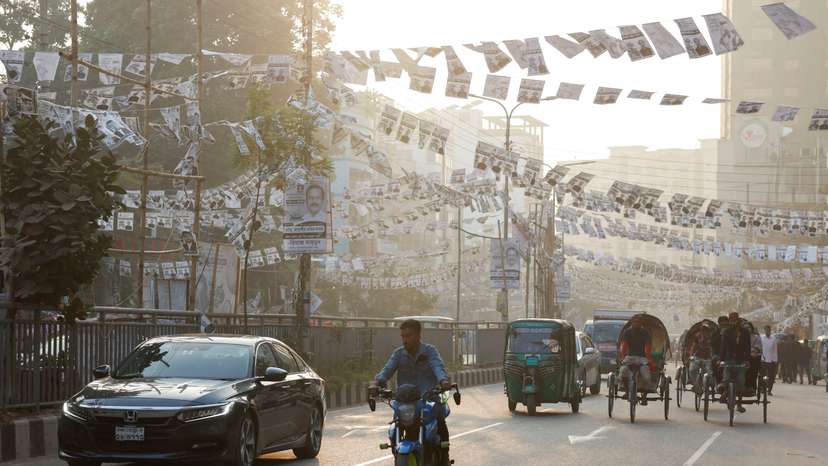 FILE PHOTO: Election campaign posters of Awami League hang on a road as traffic moves past ahead of the general election, in Dhaka