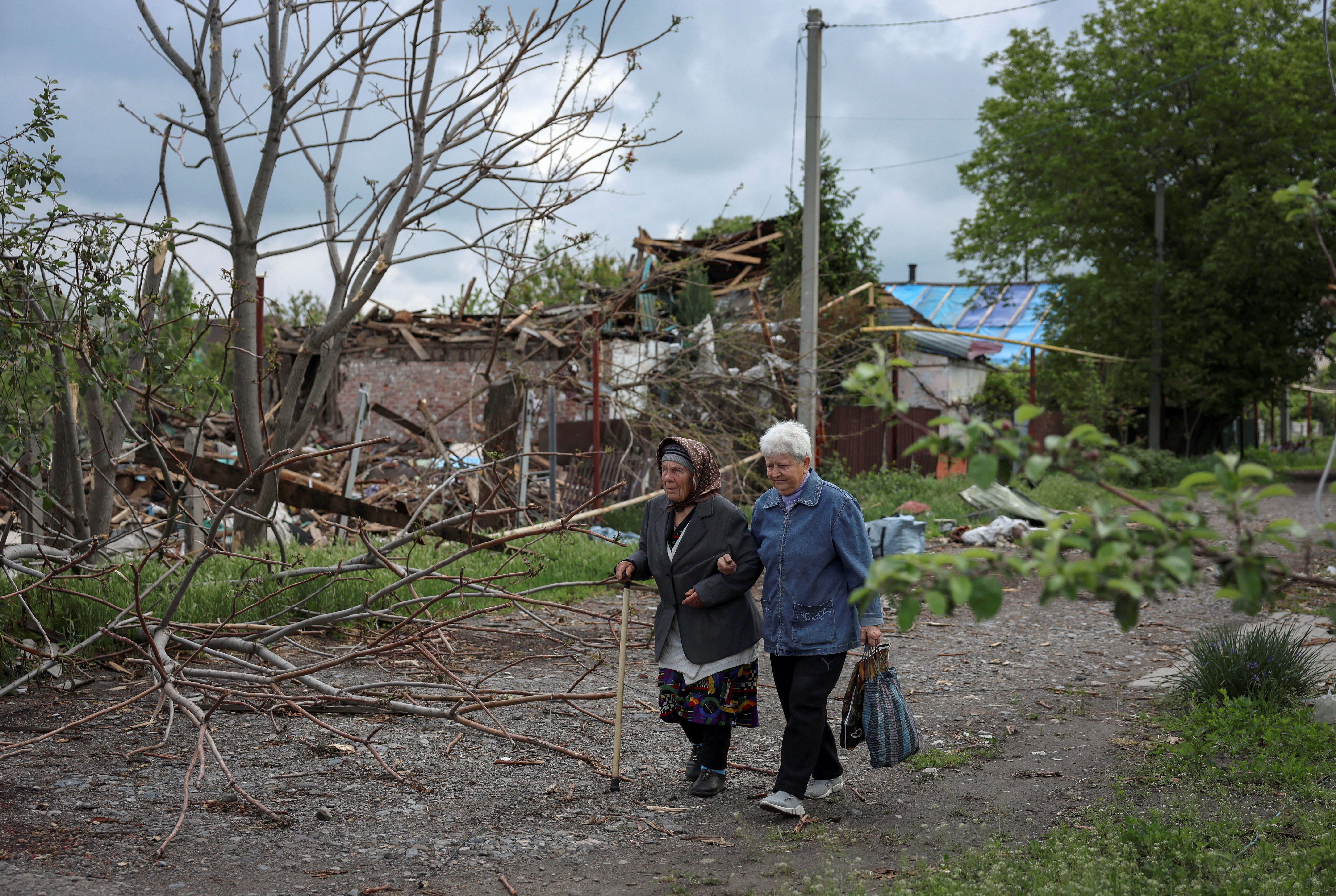 FILE PHOTO: Residents walk at a street near buildings in the frontline town of Pokrovsk