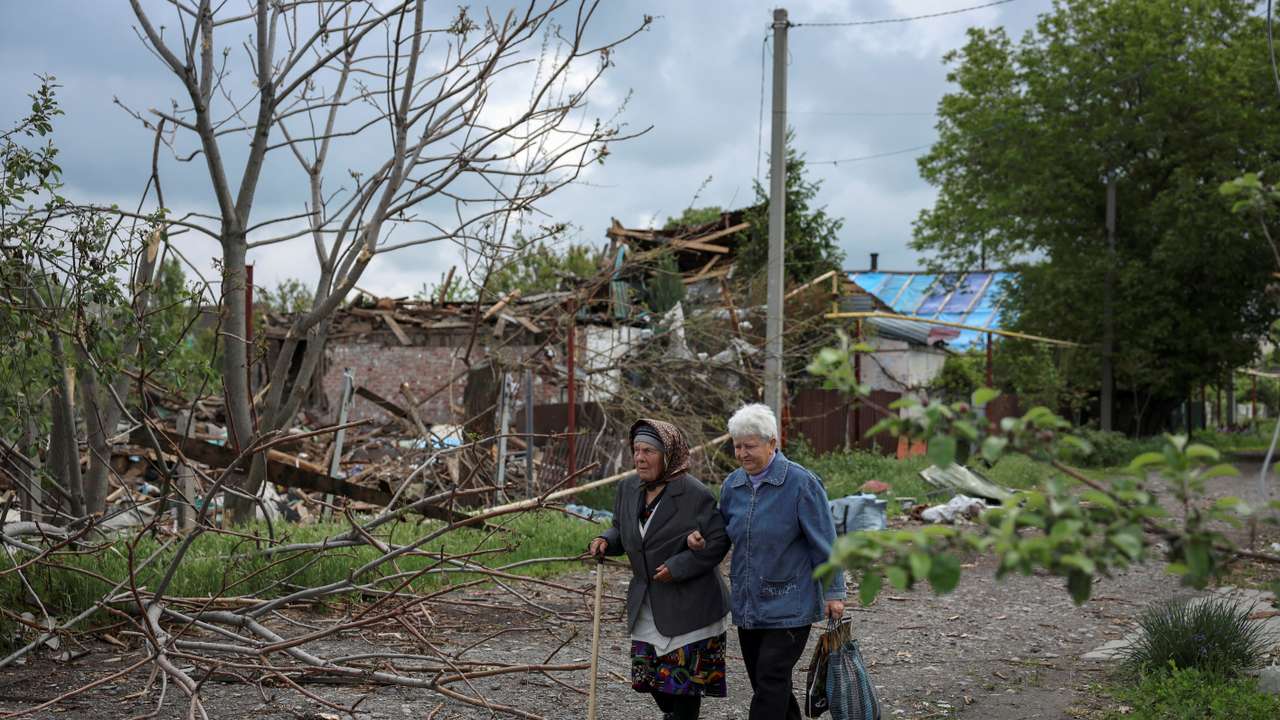 FILE PHOTO: Residents walk at a street near buildings in the frontline town of Pokrovsk
