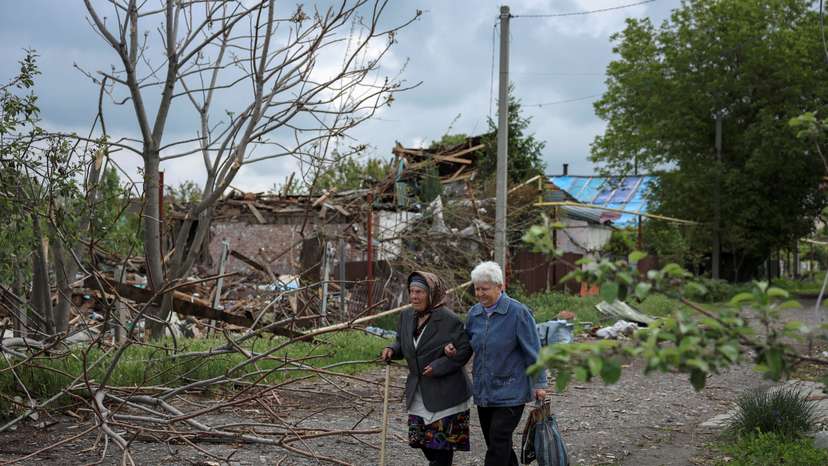 FILE PHOTO: Residents walk at a street near buildings in the frontline town of Pokrovsk