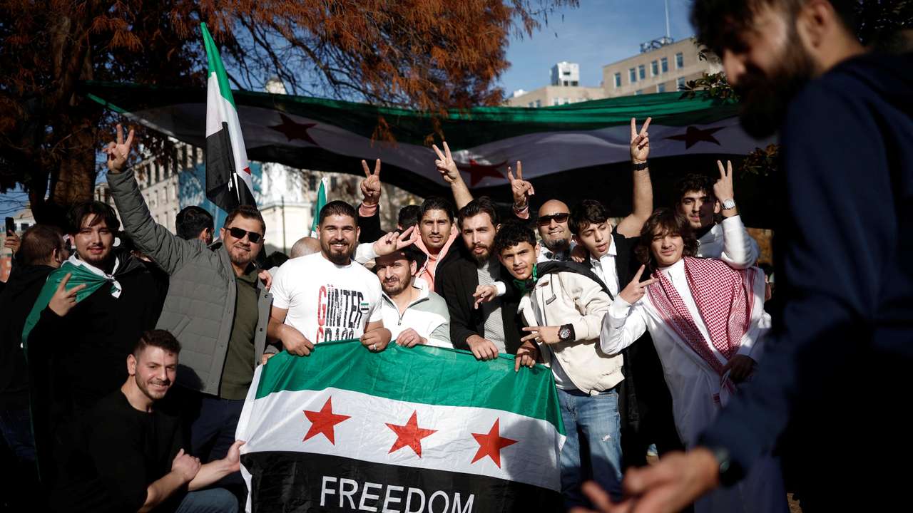 People gather in Washington, after Syrian rebels announced that they have ousted President Bashar al-Assad