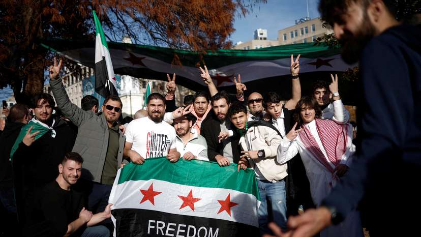 People gather in Washington, after Syrian rebels announced that they have ousted President Bashar al-Assad