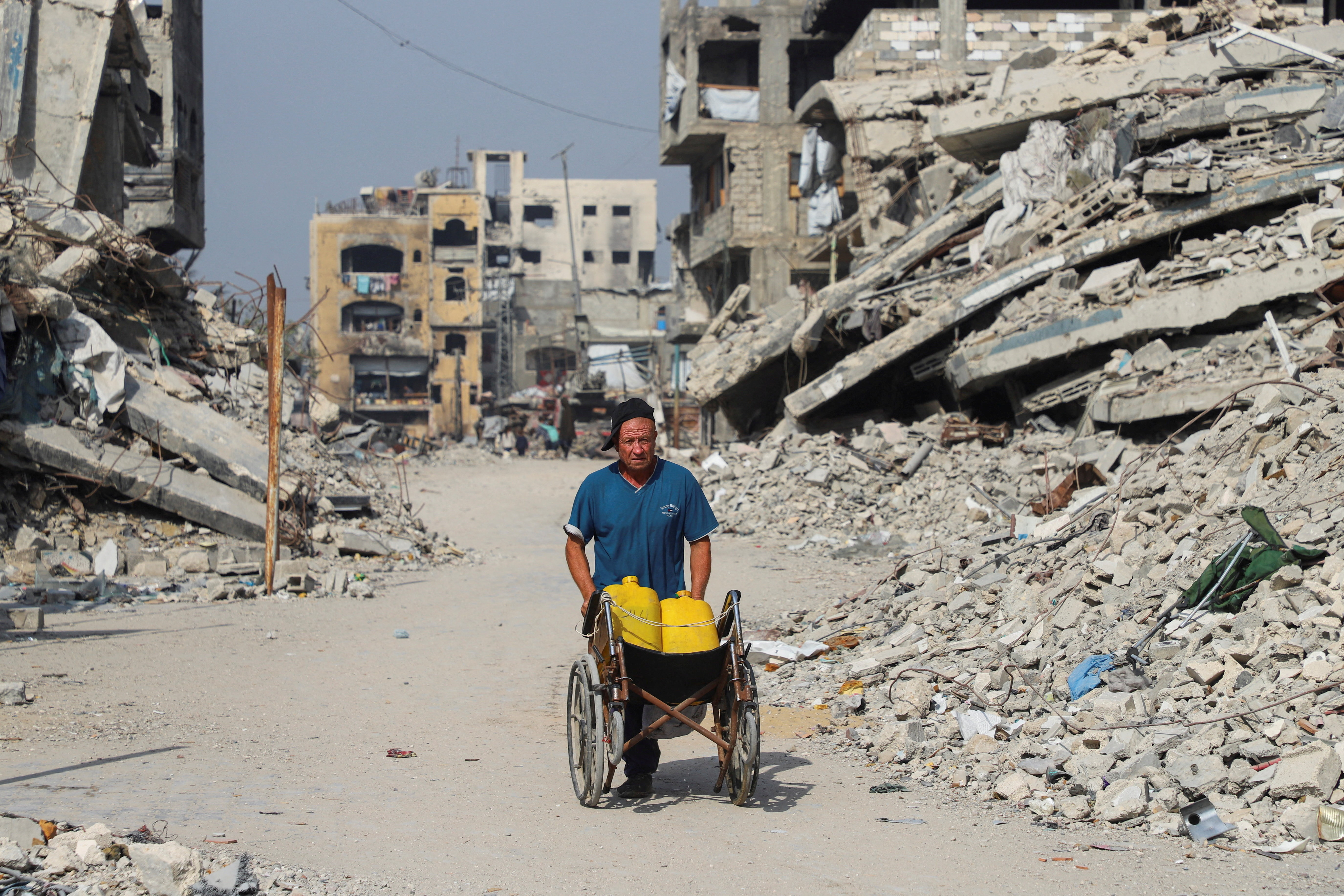 A Palestinian man walks near the so-called 'yellow line', from which Israeli troops withdrew under the ceasefire, in Gaza City