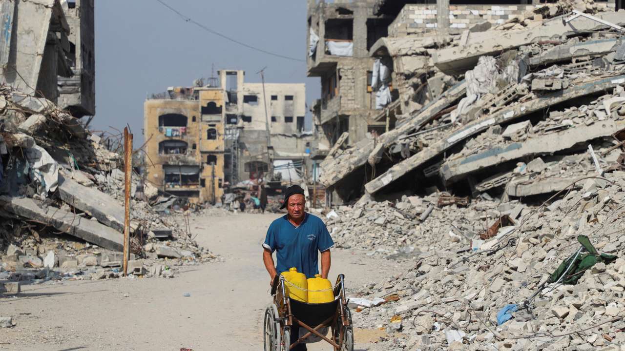 A Palestinian man walks near the so-called 'yellow line', from which Israeli troops withdrew under the ceasefire, in Gaza City