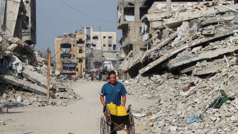 A Palestinian man walks near the so-called 'yellow line', from which Israeli troops withdrew under the ceasefire, in Gaza City