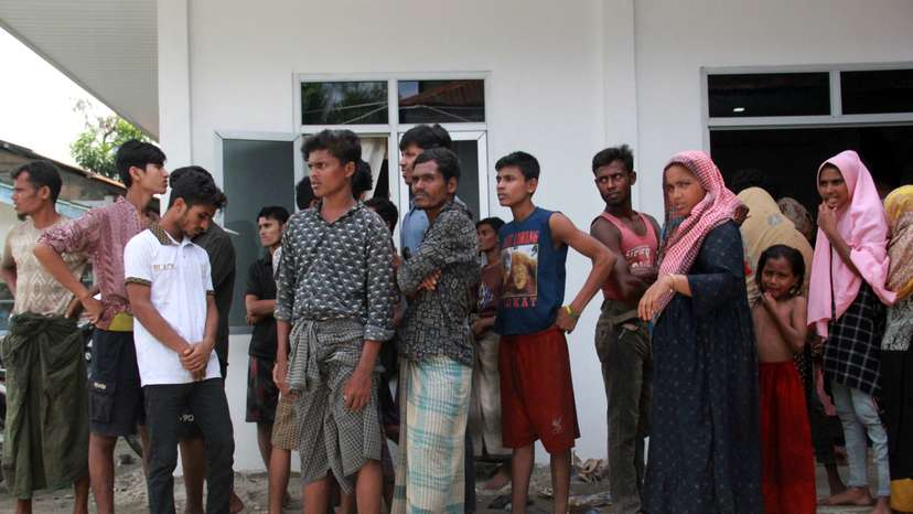 Rohingya refugees are pictured at a temporary shelter after they landed at Labu Pekan beach