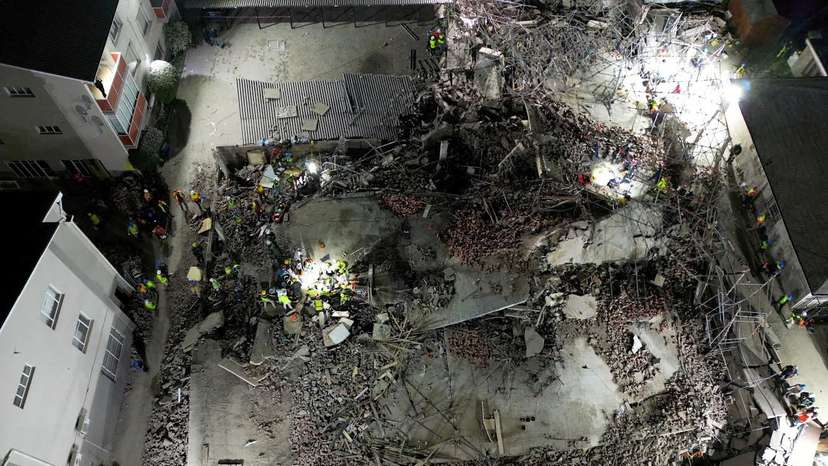 A drone view of the scene of a building collapse where several construction workers are thought to be trapped