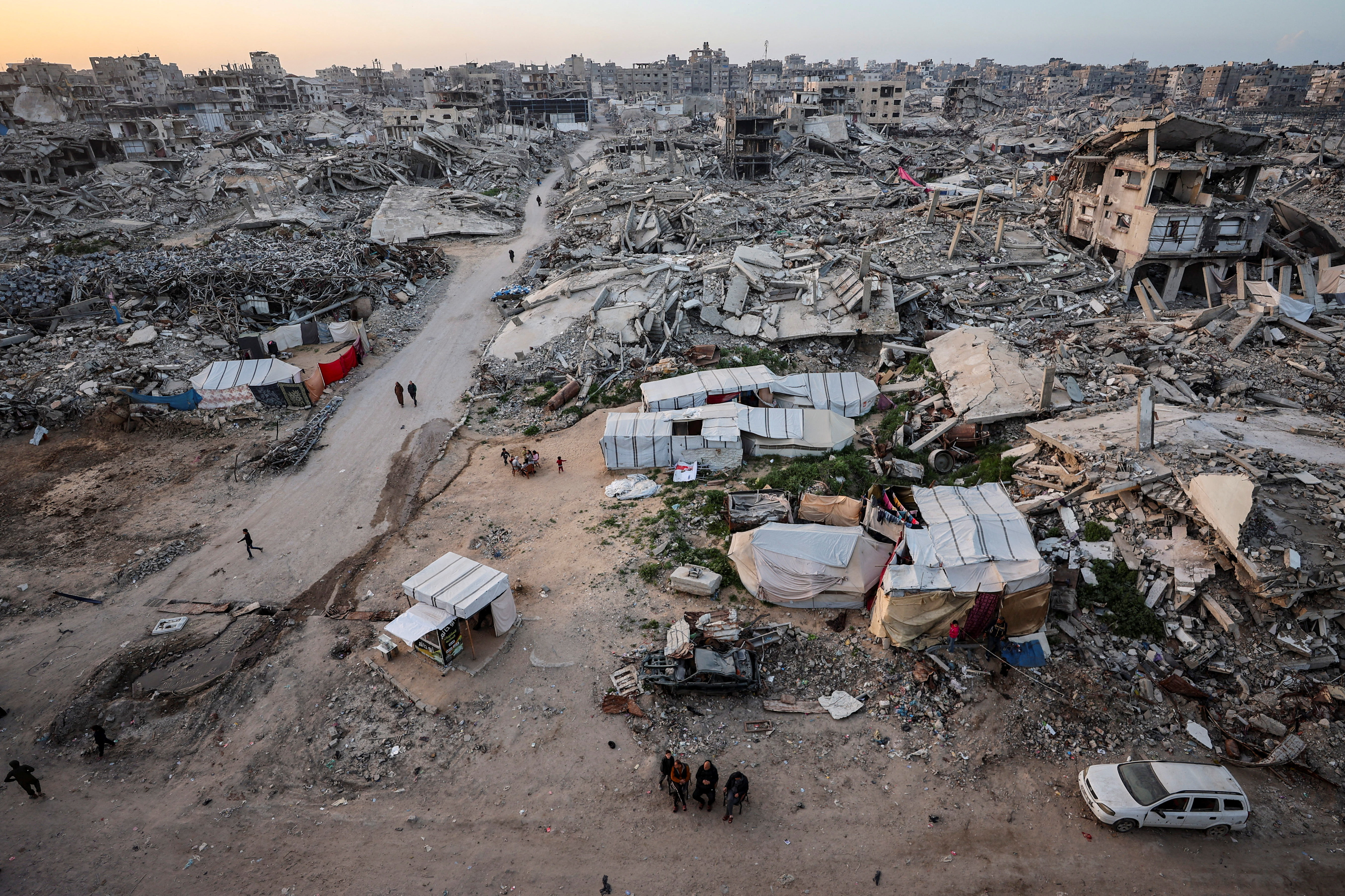Palestinians gather near the rubble of destroyed residential buildings on the first day of the holy month of Ramadan, in Gaza City