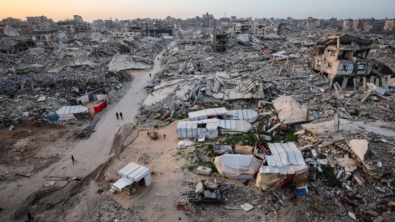 Palestinians gather near the rubble of destroyed residential buildings on the first day of the holy month of Ramadan, in Gaza City