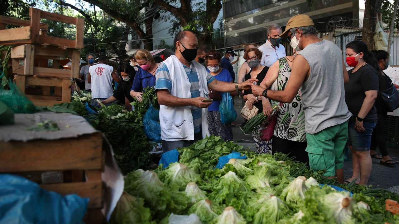 FILE PHOTO: Consumers shop at a weekly street market in Rio de Janeiro