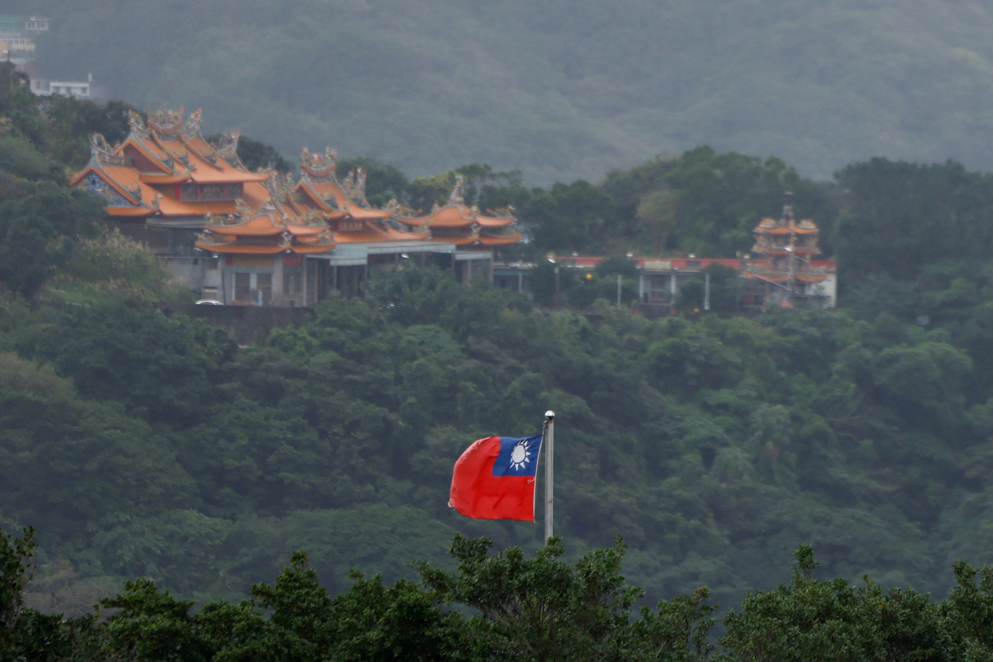 A Taiwan flag flutters in Keelung, as China conducts "Justice Mission 2025" military drills around Taiwan