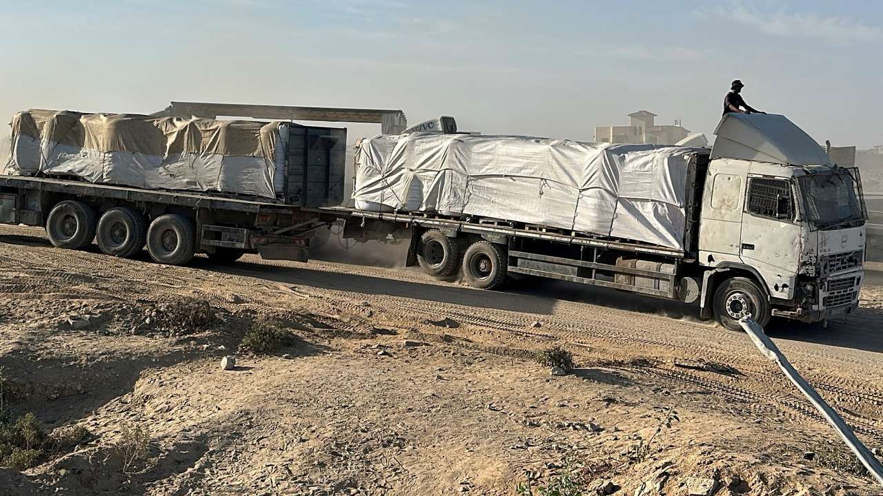Trucks carry aid for Palestinians in Deir Al-Balah