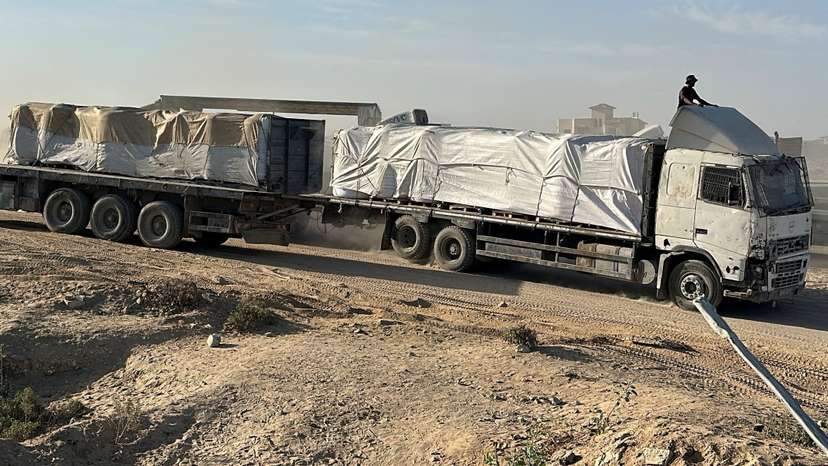 Trucks carry aid for Palestinians in Deir Al-Balah