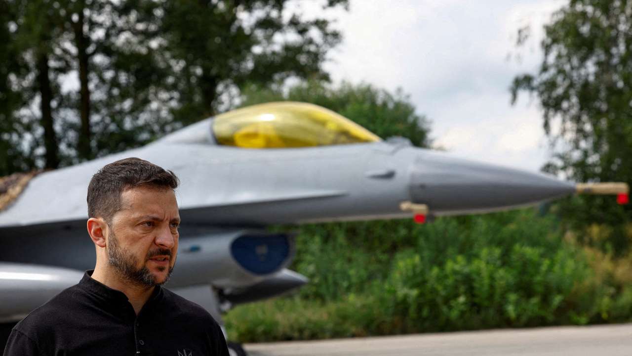 FILE PHOTO: Ukraine's President Zelenskiy speaks to the media in a front of an F-16 fighting aircraft after marking the Day of the Ukrainian Air Forces in an undisclosed location in Ukraine