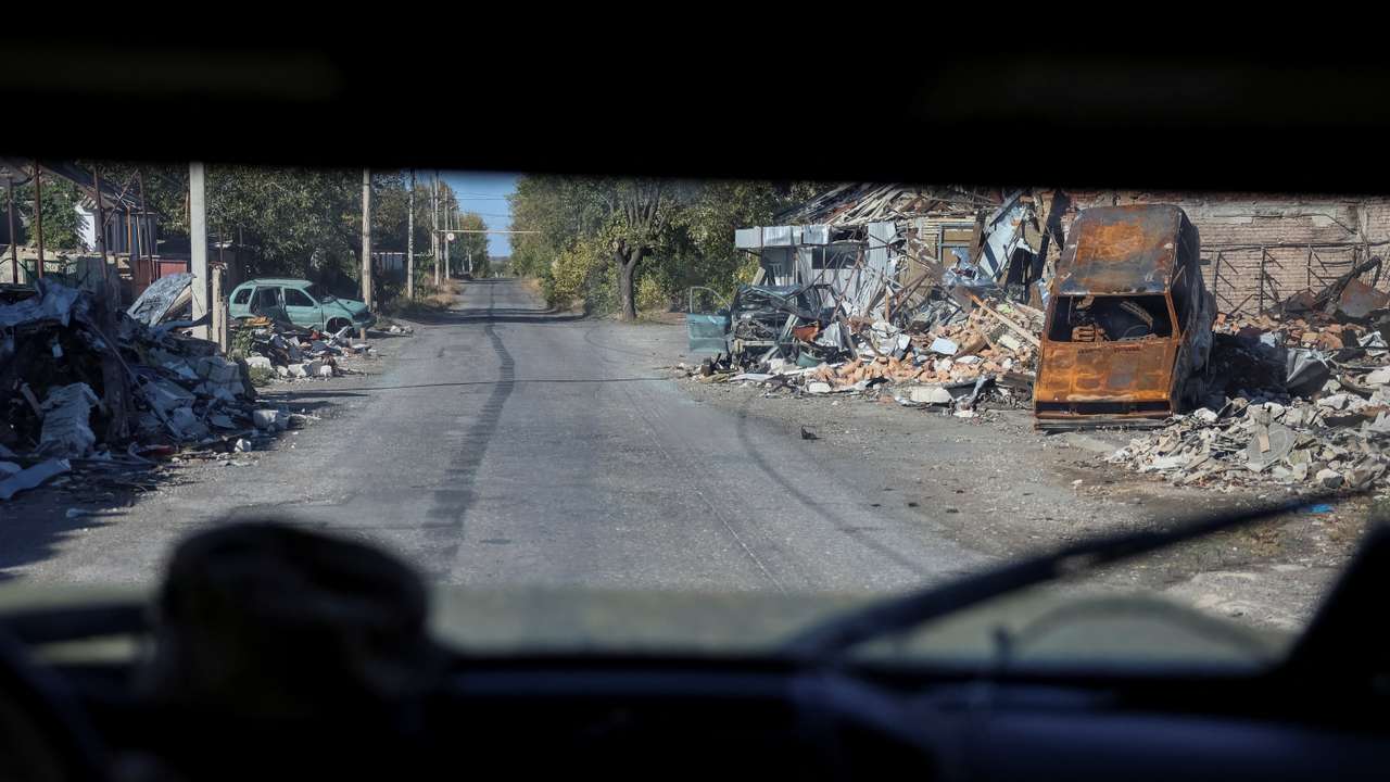 Ukrainian servicemen drive a car in the town of Selydove