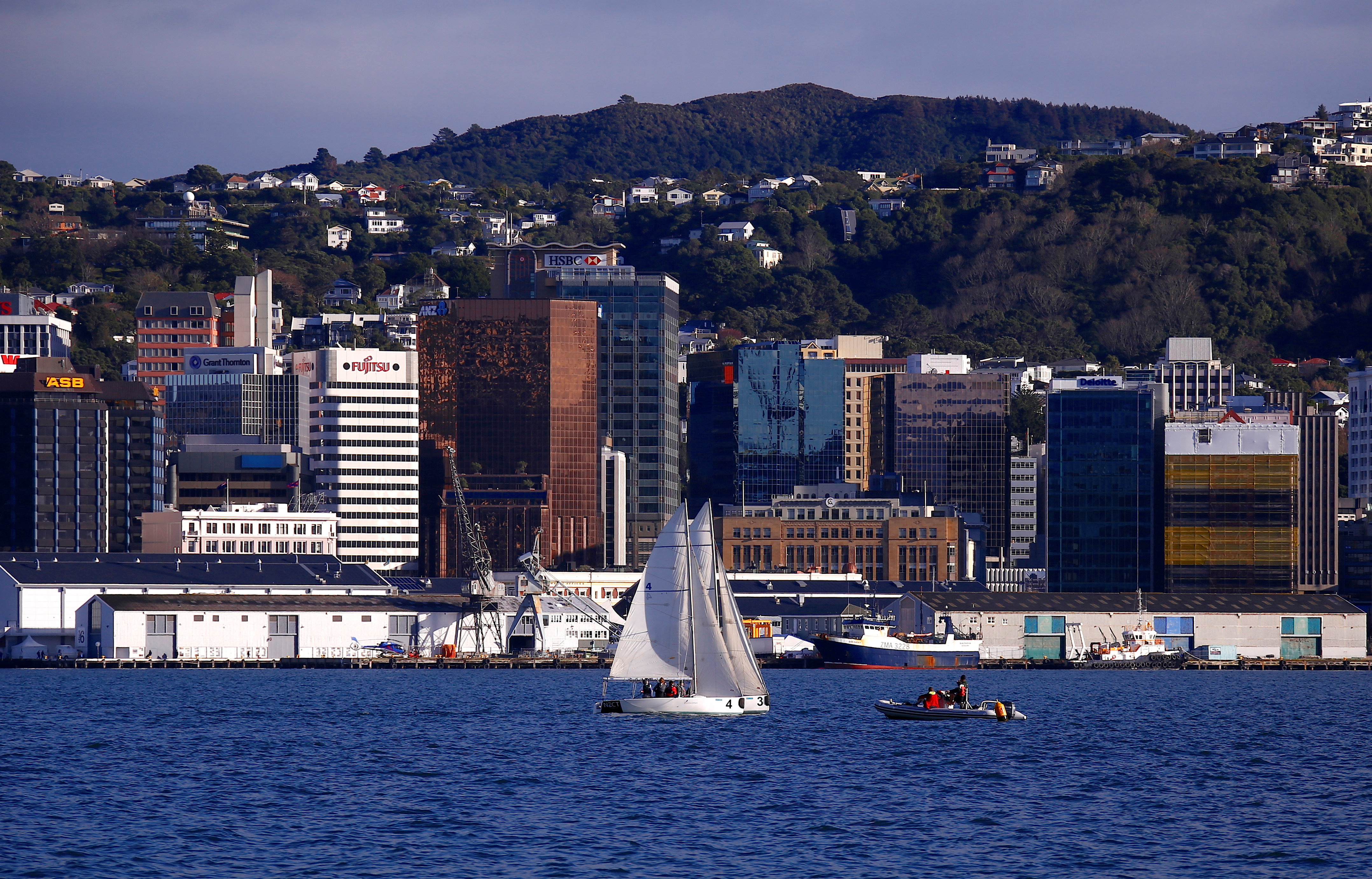 A sailing boat can be seen in front of the central business district of Wellington in New Zealand