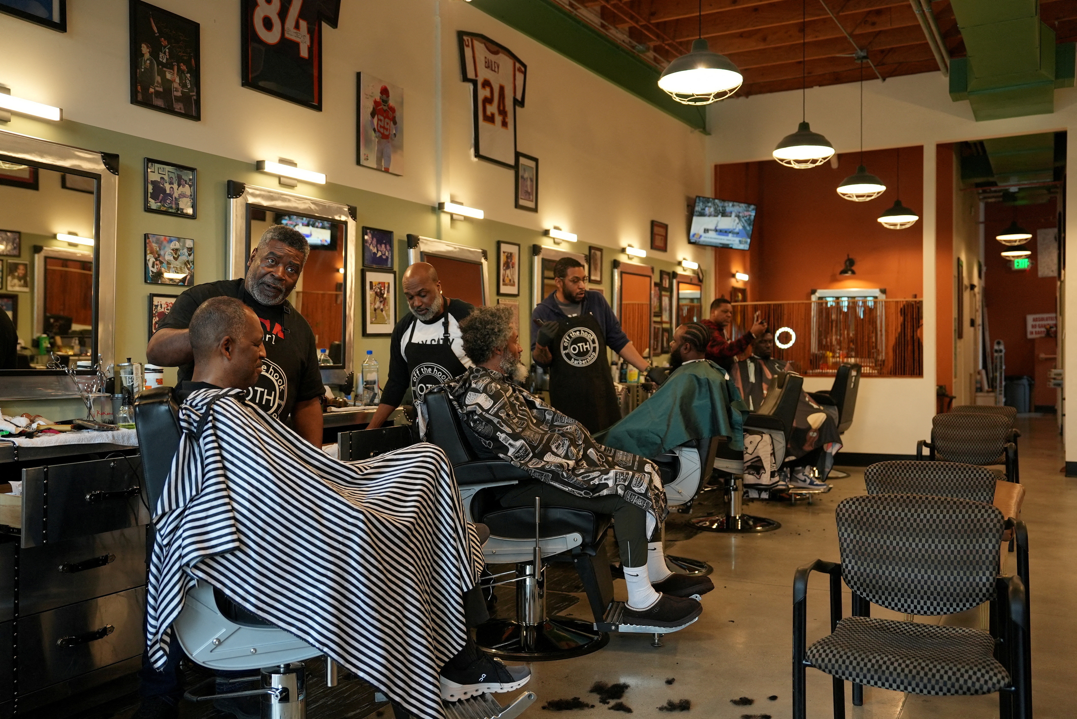 People get their hair cut at the Off the Hook barbershop in Atlanta
