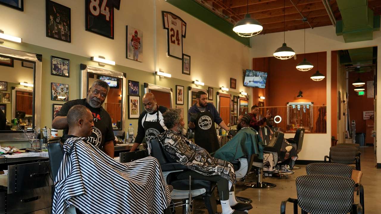 People get their hair cut at the Off the Hook barbershop in Atlanta