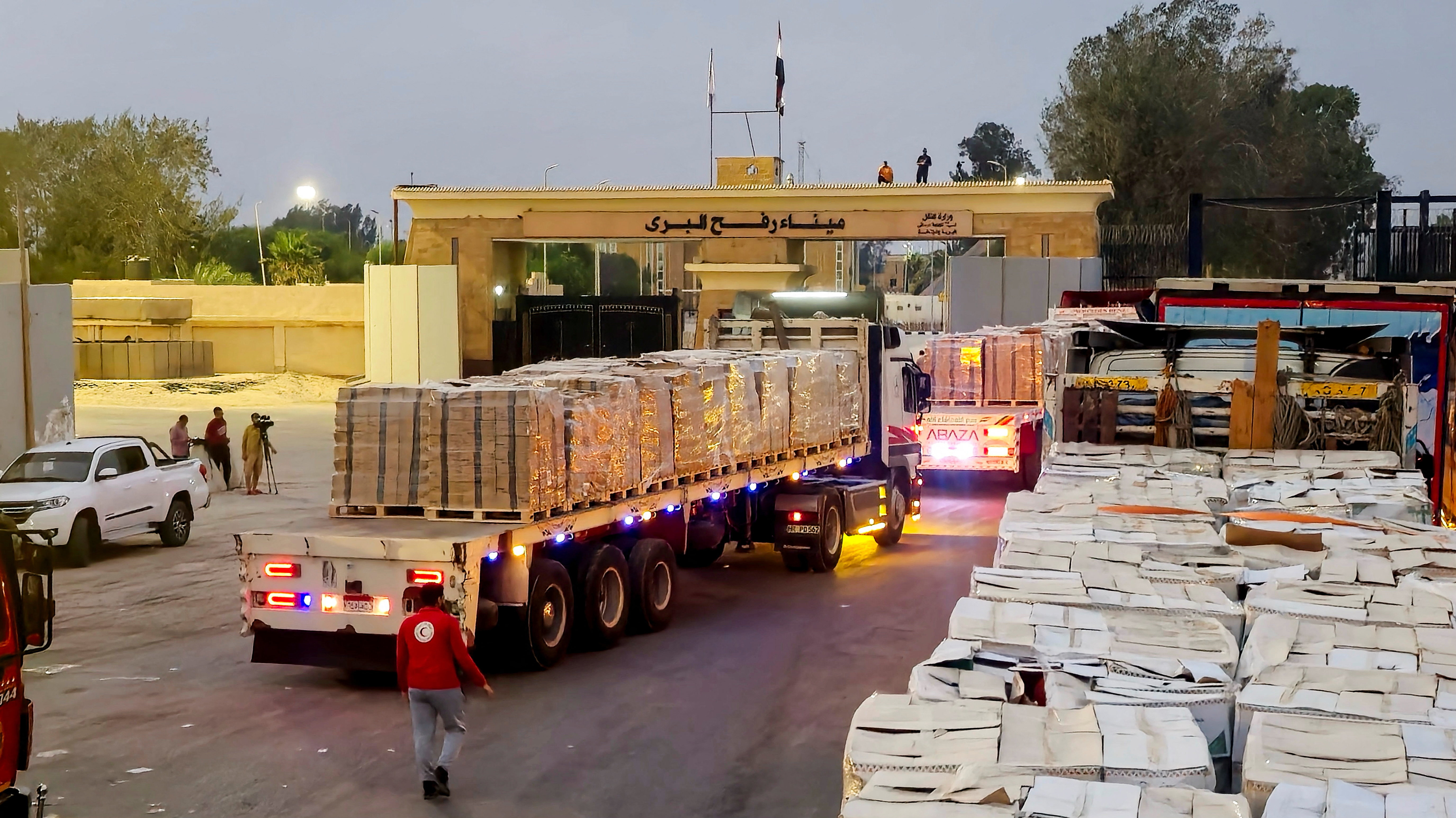 Trucks carrying humanitarian aid line up near the Rafah border crossing between Egypt and the Gaza Strip