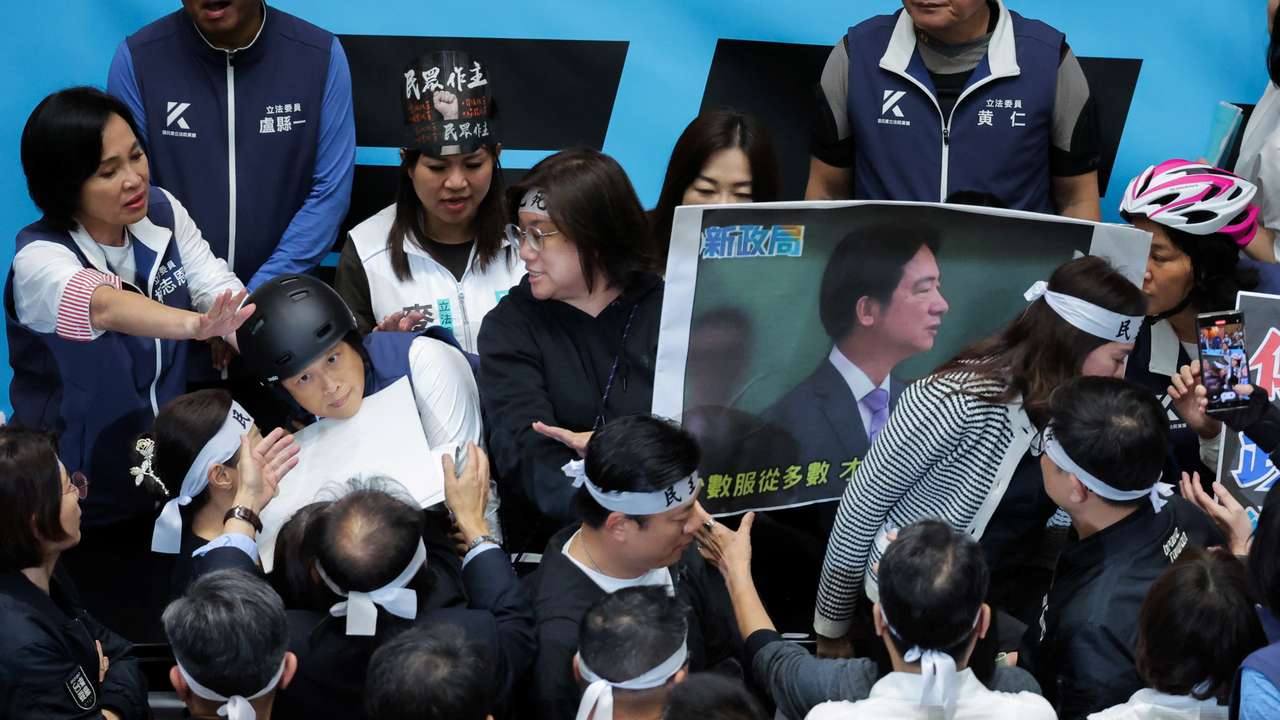 Lawmakers protest and fight during a parliamentary session in Taipei