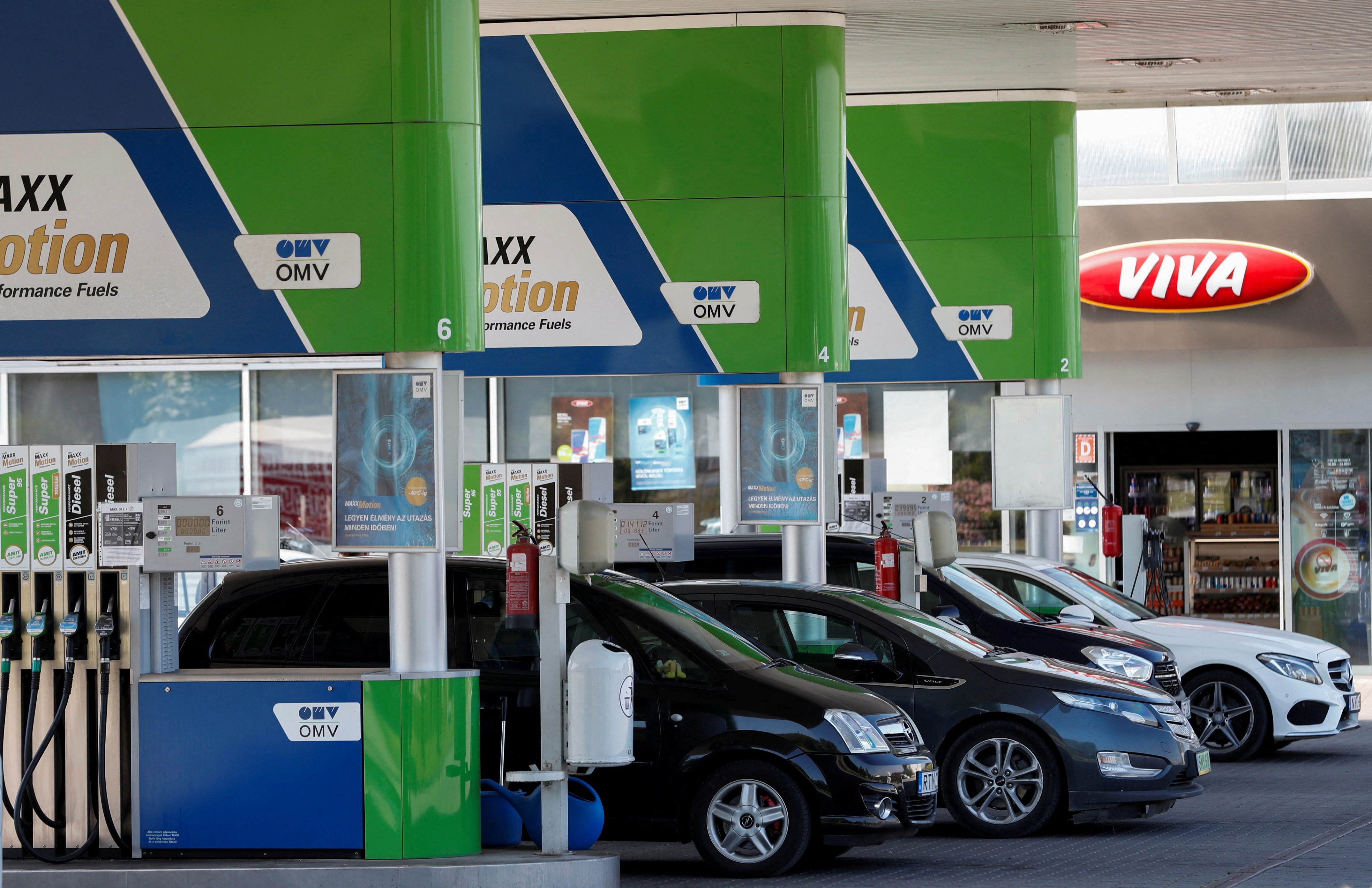 FILE PHOTO: Cars at an OMV petrol station near the Slovakian border in Esztergom